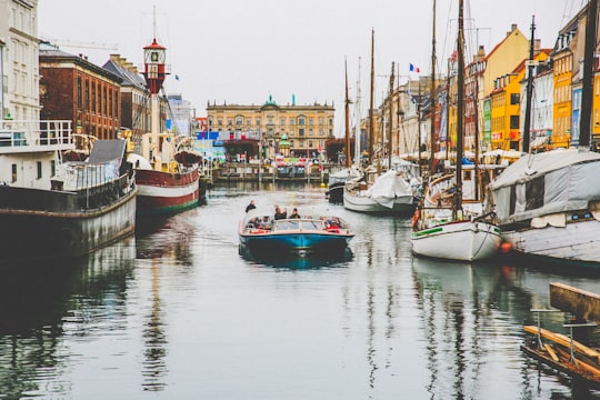 people riding on cuddy boat in Nyhavn Denmark
