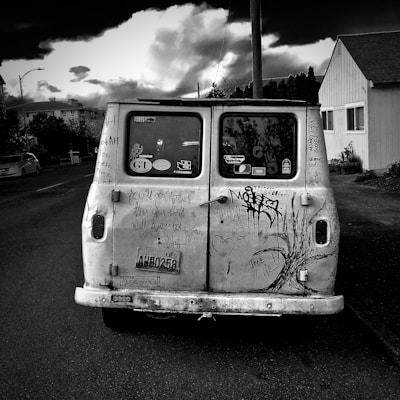 The iconic ugly van parked by a cozy neighborhood street, ready for the next trip.