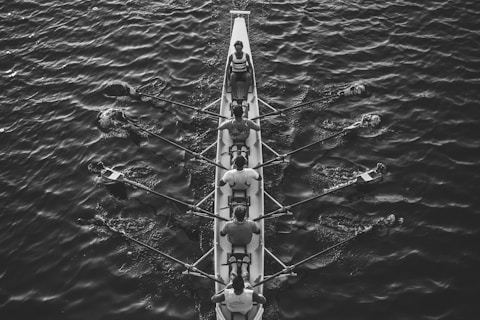 people riding boat on body of water