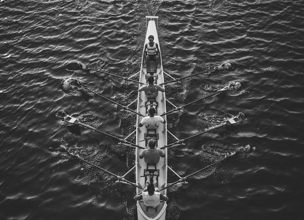 people riding boat on body of water