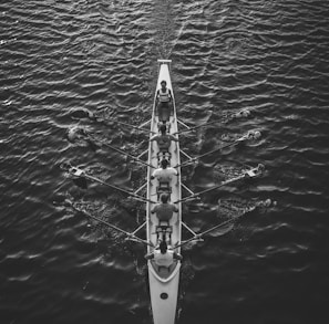 people riding boat on body of water