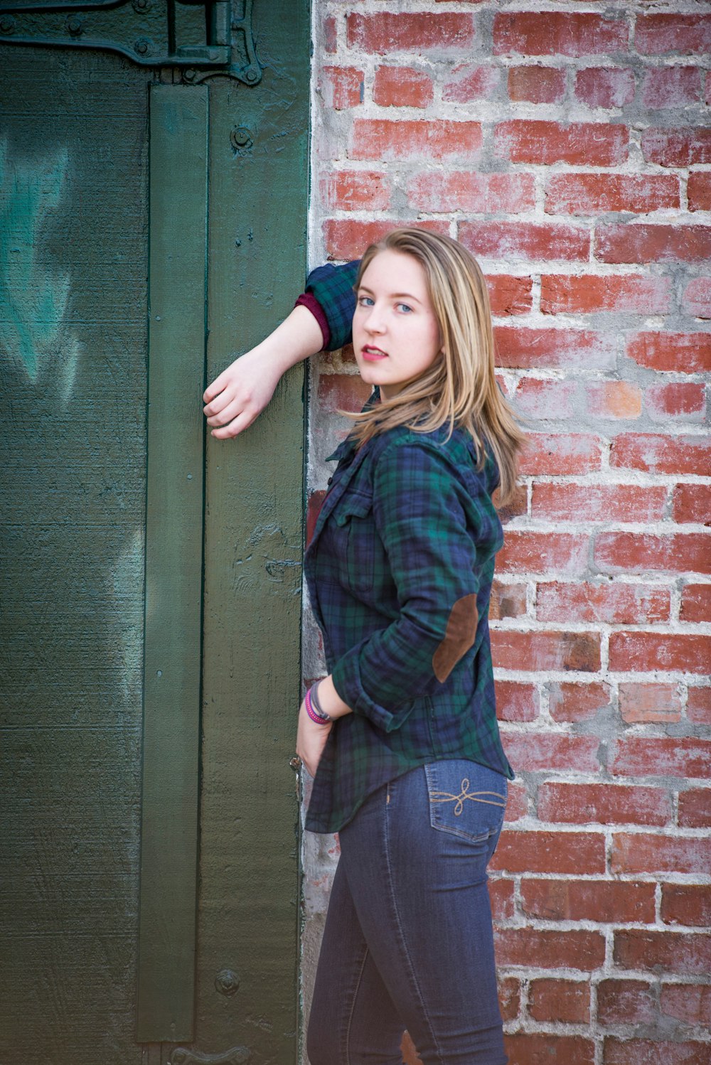 woman leaning on wall