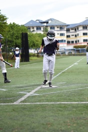 A group of enthusiastic high school baseball players celebrating a home run on the field.