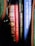 A collection of books is visible with titles such as 'American Historical Documents', 'Fair Play', 'More Natural Cures Revealed', and parts of others. The books are neatly lined up with various colored spines, including red, black, and blue.