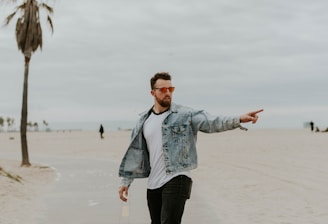 men's washed denim jacket riding a skateboard