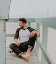 man smiling while sitting on floor during daytime