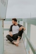 man smiling while sitting on floor during daytime