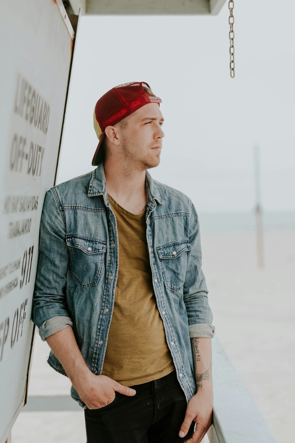 man leaning on wall