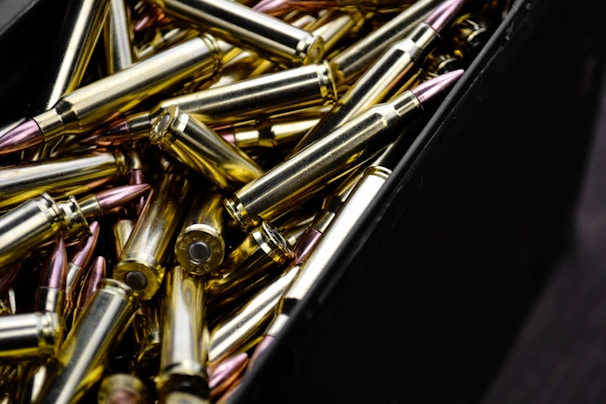 A variety of shiny ammunition cartridges neatly arranged.