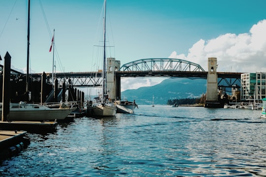 boat under bridge in Burrard Street Bridge Canada