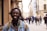 selective focus of man smiling near building