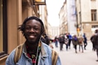 selective focus of man smiling near building