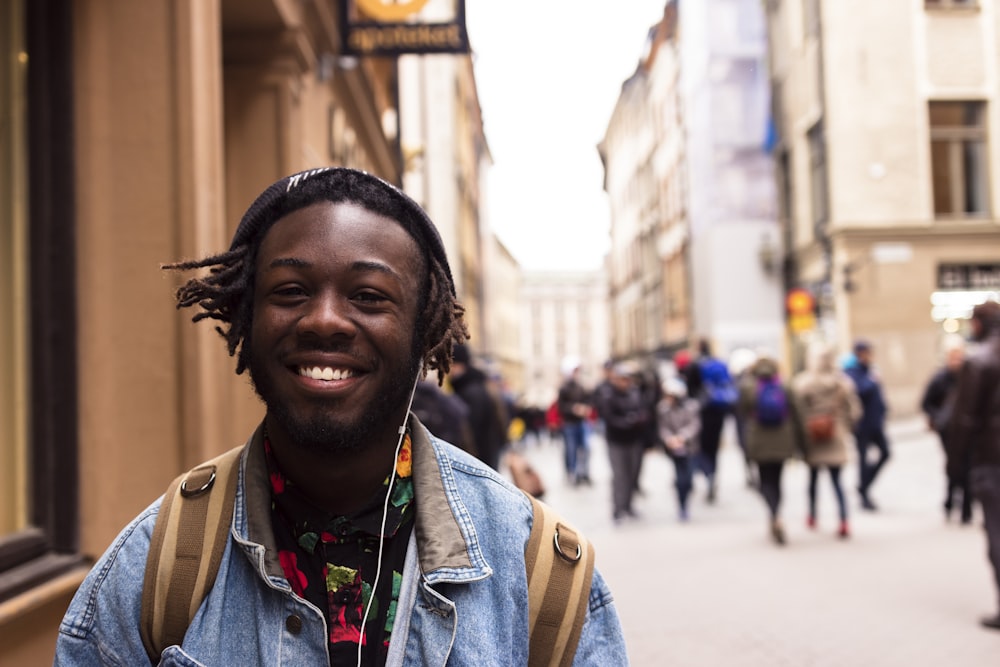 selective focus of man smiling near building