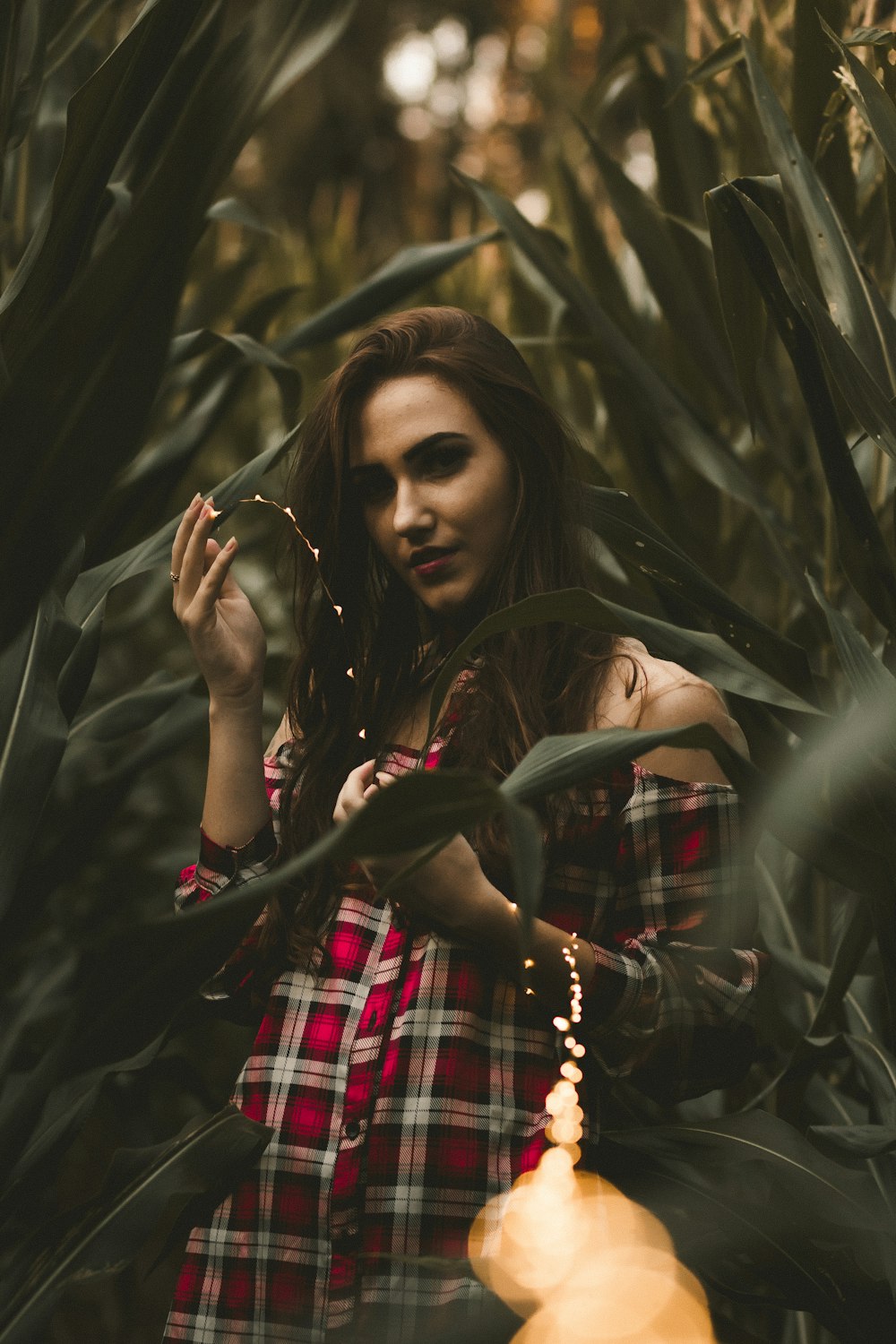 a woman standing in a field of tall grass