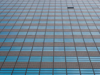 Close-up of a modern Chicago high-rise window reflecting cityscape, no humans.