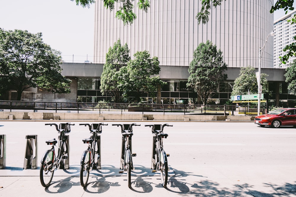 four black bike parking near road