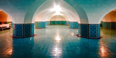 Spacious reception hall with warm earthy tones and elegant lighting set for an event.