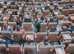 high-angle photography of group of people sitting at chairs