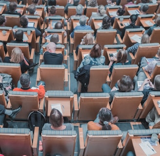 high-angle photography of group of people sitting at chairs