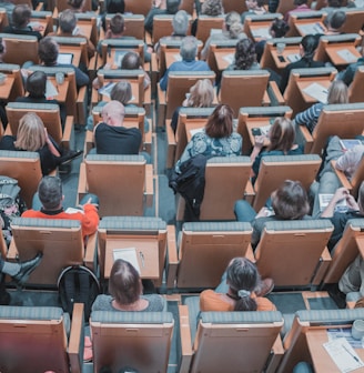 high-angle photography of group of people sitting at chairs