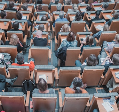 high-angle photography of group of people sitting at chairs