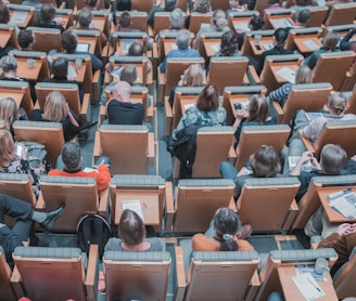 high-angle photography of group of people sitting at chairs