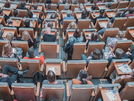 high-angle photography of group of people sitting at chairs