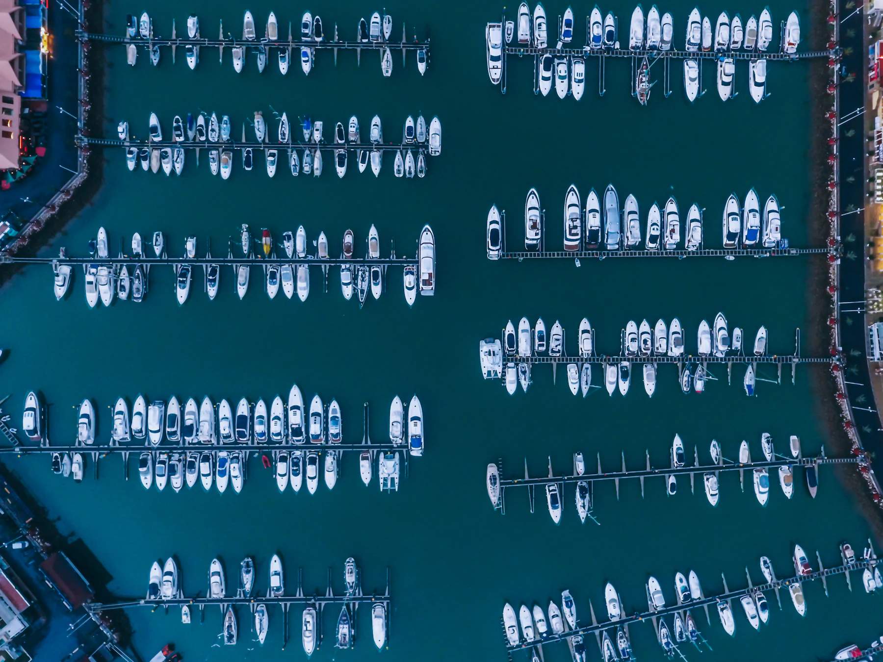 Boats moored in a marina, seen from above