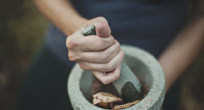person grinding on mortar and pestle