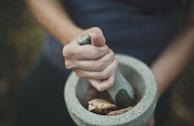 person grinding on mortar and pestle