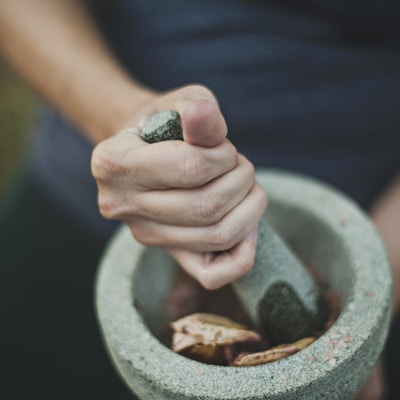 person grinding on mortar and pestle