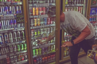 man getting can in beverage cooler