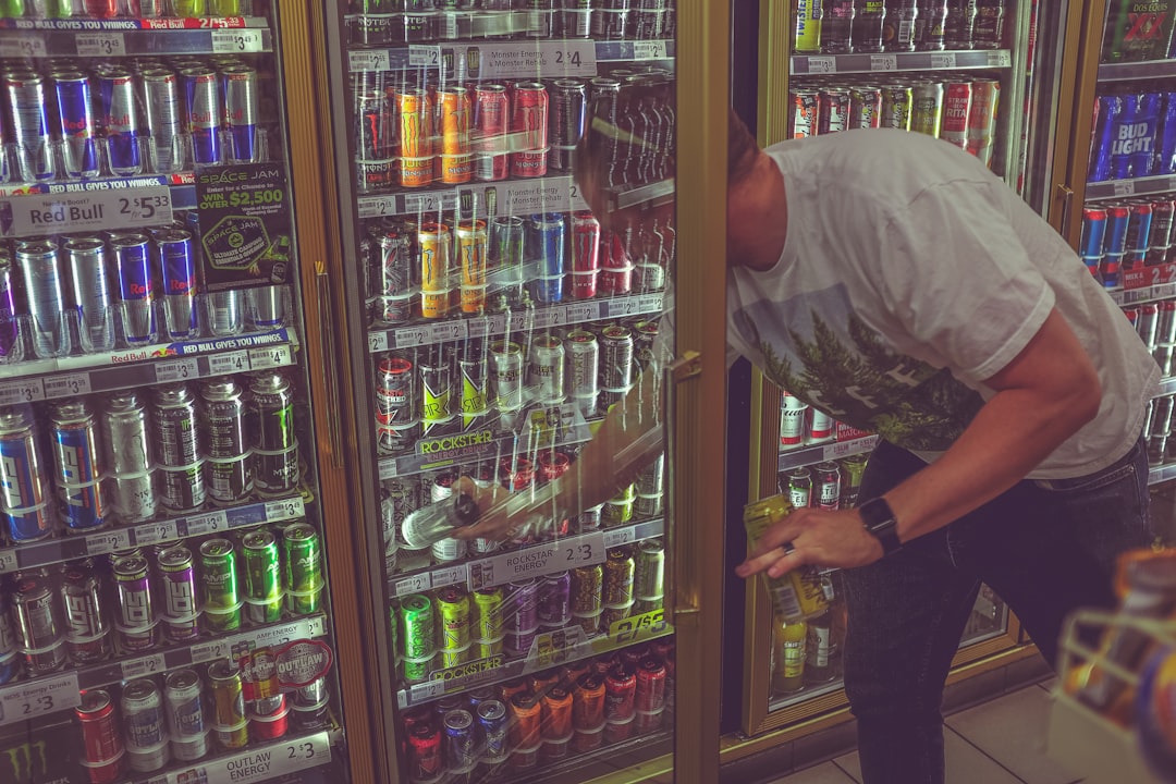 man getting can in beverage cooler