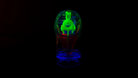 Close-up of a sleek black 3D printed object with glowing orange neon highlights on a dark background.