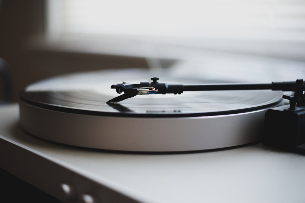 tilt shift lens photography of gray and black turntable