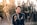smiling man standing near green trees