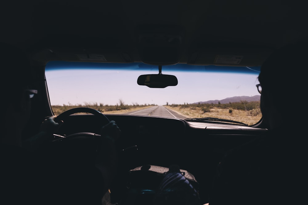 silhouette of person driving inside car