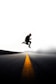 man jumping above gray and yellow concrete road at daytime