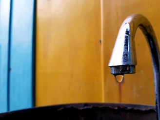 Icon of a water droplet and wrench illustrating plumbing services.