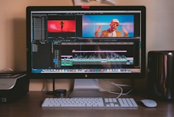 turned on iMac and Apple Magic Keyboard and mouse on table