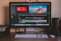 turned on iMac and Apple Magic Keyboard and mouse on table