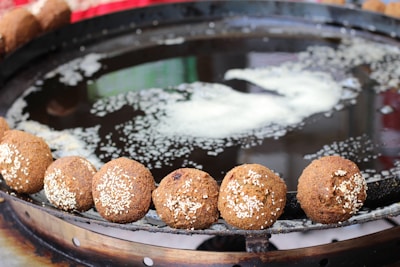 A chef preparing fresh falafel in a bustling kitchen.