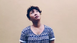 woman wearing black and white shirt looking above