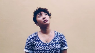 woman wearing black and white shirt looking above