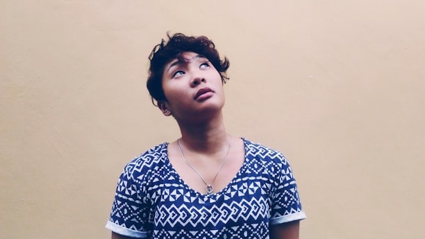 woman wearing black and white shirt looking above