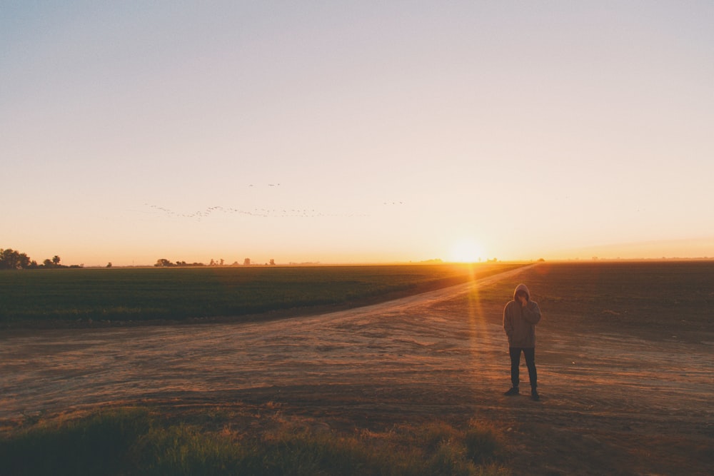 A man standing in Mexicali in desert during sunset