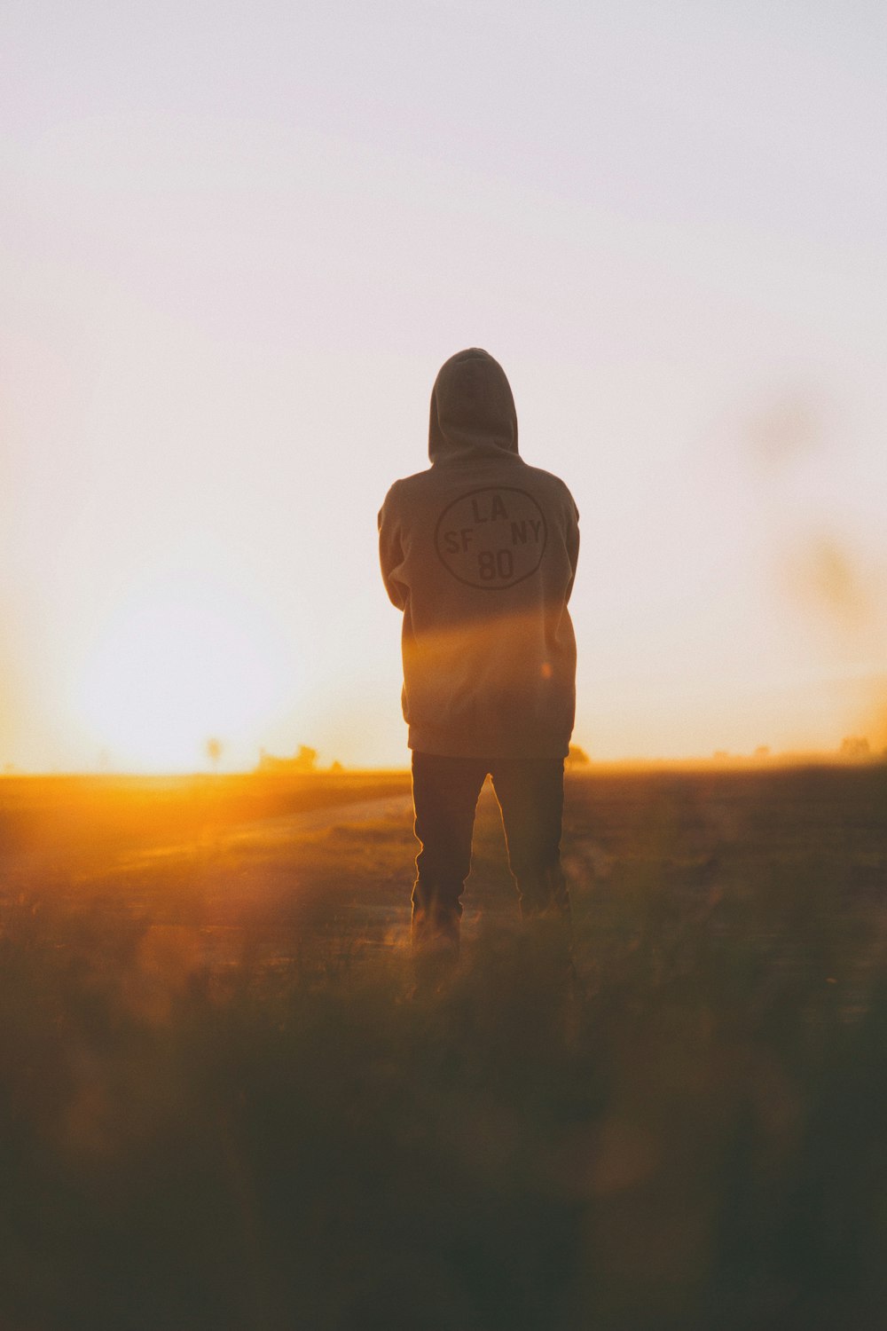 person in hoodie standing on field