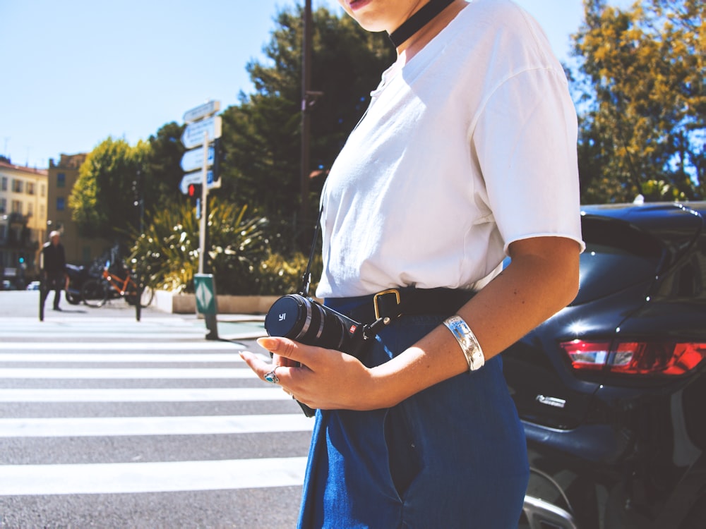 person holding black camera close-up photography