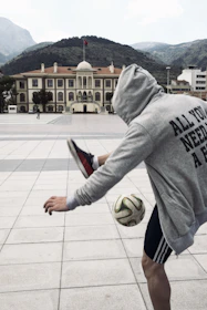 Close-up of an amateur player skillfully controlling the ball with local Cartagena buildings in the background.