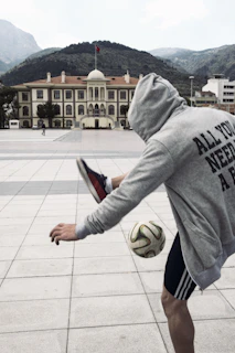 Close-up of an amateur player skillfully controlling the ball with local Cartagena buildings in the background.